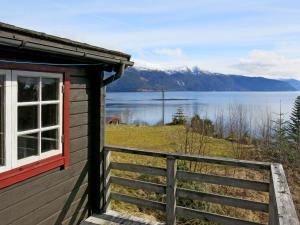 a cabin with a view of a lake and mountains at Chalet Haugly - FJS022 by Interhome in Balestrand