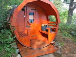 a small wooden hobbit house with a door and shelves at Holiday Home Maria - FJS114 by Interhome in Balestrand