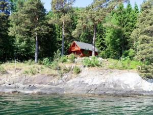 a cabin on the shore of a body of water at Holiday Home Franz - FJS111 by Interhome in Balestrand