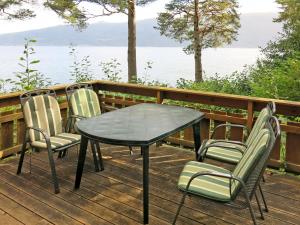 a table and chairs on a deck overlooking the water at Holiday Home Franz - FJS111 by Interhome in Balestrand