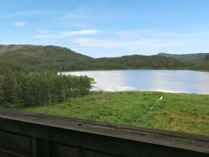 a view of a lake from a fence at Chalet Moebu - SOO040 by Interhome in Mjåvatn