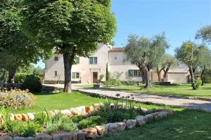 a house with a garden in front of it at La Vieille Ferme de Grasse in Grasse