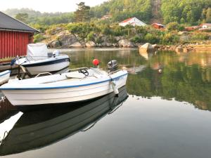 a boat is docked in a body of water at Holiday Home Geirbu - SOW403 by Interhome in Mandal