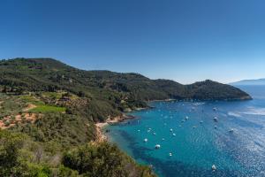 an aerial view of a beach with boats in the water at Boutique Hotel Torre Di Cala Piccola in Porto Santo Stefano