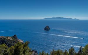 a small island in the middle of the ocean at Boutique Hotel Torre Di Cala Piccola in Porto Santo Stefano