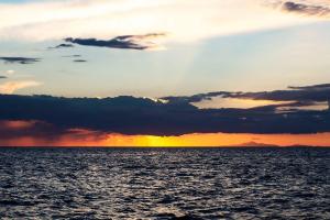 a sunset over a large body of water at Boutique Hotel Torre Di Cala Piccola in Porto Santo Stefano