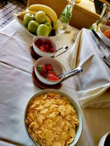 a table with bowls of fruit and plates of food at Villa Andor in Ankaran