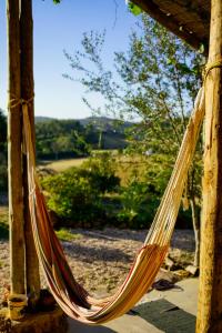 a hammock hanging from a pergola at The Hobbit House - Montes da Ronha in Odemira