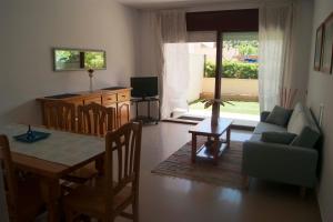 a living room with a table and a couch at Mediterranea in La Pineda