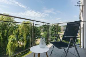 a balcony with a chair and a vase on it at City Center - Torunska 18 by Apartmore in Gdańsk