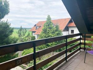 a balcony with a view of a house at Ela's Apartment in Komenda