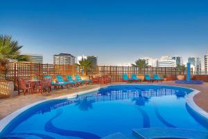 a swimming pool on the roof of a hotel at City Seasons Suites in Dubai