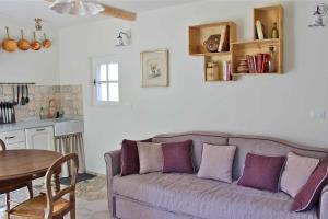 a living room with a couch and a table at La Vieille Ferme de Grasse in Grasse