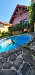 a swimming pool in front of a house at Ubytovanie U Babky in Veľký Slavkov