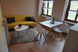 a living room with a couch and a table and chairs at Weingut Göbel-Schausten in Ernst +15 photos