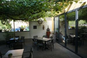 a patio with tables and chairs in a restaurant at Weingut Göbel-Schausten in Ernst