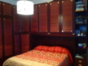 ヴェンティミリアにあるLa casa di Marcoのベッドルーム1室(木製のシャッターとランプ付きのベッド1台付)