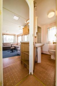 a kitchen and living room with a sink and a toilet at Rowyhills in Rowy