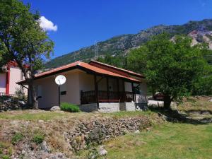 a small house in front of a mountain at Vila Ena in Stanišiči