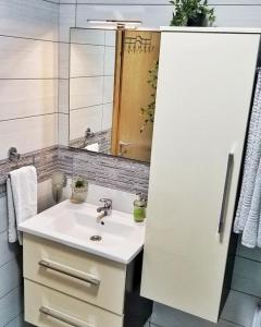 a bathroom with a sink and a mirror at Apartman Sunset Trebinje in Trebinje