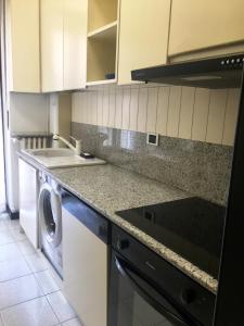 a kitchen with a washer and dryer in it at SAY YES MILANO CITY LIFE in Milan