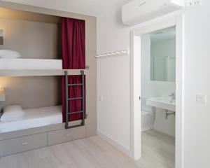 A bed or beds in a room at Broz Hostel