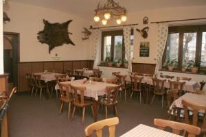 a dining room with tables and chairs and windows at Penzion Aladdin in Teplice
