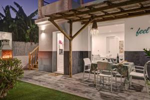a dining area with a table and chairs on a patio at Villa El Ranchito By Seric, 15' walking to the beach in Torremolinos