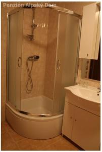 a bathroom with a shower and a sink at Alpský dom Vitanová in Vitanová
