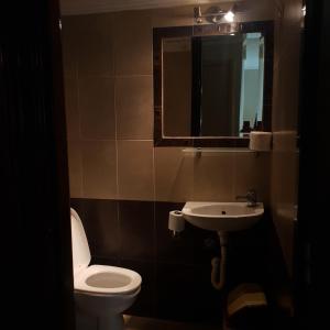 a bathroom with a toilet and a sink and a mirror at Del Mar in Nea Vrasna +14 photos