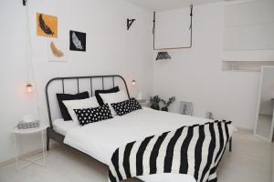una camera da letto con un letto con cuscini bianchi e neri di Korcula perfect spot a Korčula