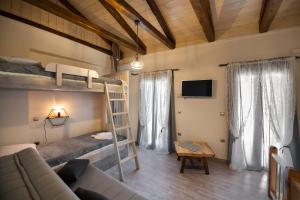 a living room with bunk beds and a couch at Stone Villa Hermione in Kariá