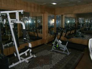 a gym with several tread machines in a room at Quality Airport Hotels in Nedumbassery
