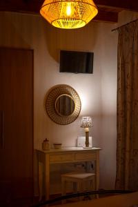 a room with a table with a mirror and a lamp at Madalena's Summer House in Adamantas