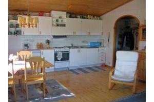 uma cozinha com armários brancos e uma mesa e cadeiras em By the Baltic sea, 2 bedrooms em Karlskrona