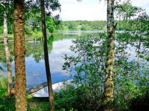 a boat sitting in the middle of a lake at Chalet Öja - HAL054 by Interhome in Oskarström