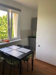 a kitchen with a table and chairs and a window at MAXI - Mielenko in Mielenko +46 photos