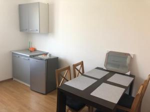 a kitchen with a table and a small refrigerator at MAXI - Mielenko in Mielenko
