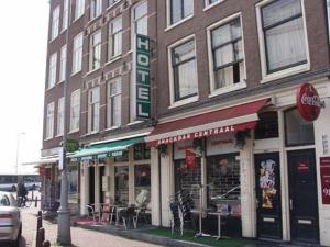 a building on the corner of a street with a store at Hotel Restaurant Old Bridge in Amsterdam