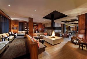 a living room with couches and a fireplace at Parkhotel Stuttgart Messe-Airport in Leinfelden-Echterdingen