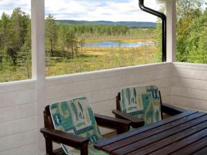 a porch with a table and chairs and a view of a lake at Chalet Kvisthån Idegranen - HJD059 by Interhome in Vemhån
