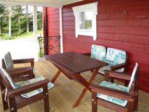 a wooden table and chairs on a porch at Chalet Kvisthån Idegranen - HJD059 by Interhome in Vemhån