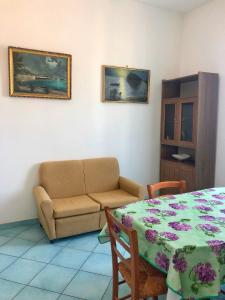 ein Wohnzimmer mit einem Sofa und einem Tisch in der Unterkunft Residenza Celeste al 28 in Ischia