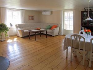 a living room with a couch and a table at Chalet Stora Gryten - NAK035 by Interhome in Askersund