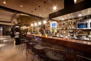 a bar with a row of chairs in a restaurant at V Lofts in Amsterdam