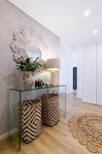 a living room with a glass table and a mirror at Kerala 49, Deluxe Flat in Historic Center in Peniche