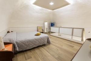 a bedroom with a bed and a wooden floor at Resina Guest House in Ercolano
