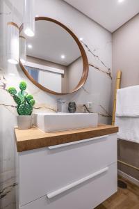 a bathroom with a sink and a mirror at Kerala 49, Deluxe Flat in Historic Center in Peniche