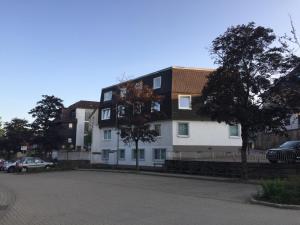 a white and brown building on a city street at Apartment der Entspannung in Braunlage