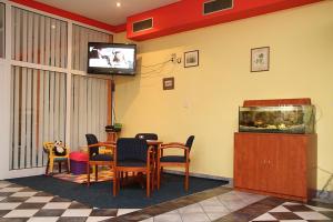 a waiting room with a table and a fish tank at Milotín in Zuberec